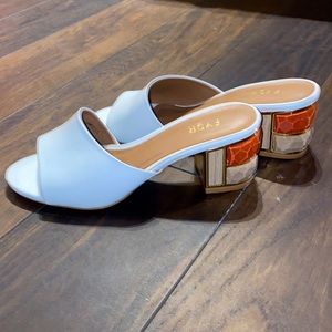 White mules, block heels, statement heel